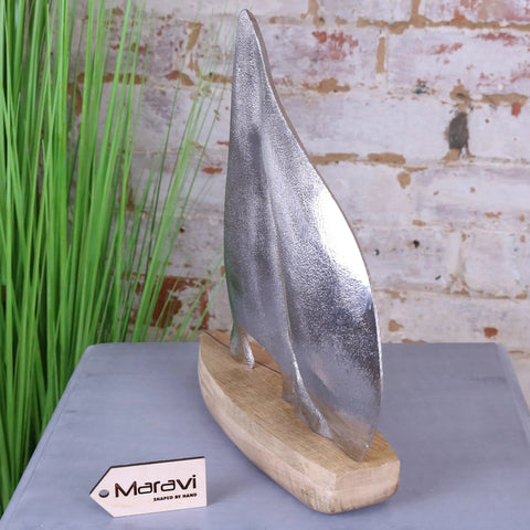 Silver metallic kasba boat ornament sculpture with textured handcrafted finish on natural wood base