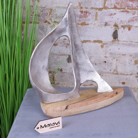 Silver metallic kasba boat ornament with textured handcrafted finish on rustic wooden base perfect as boat ornament