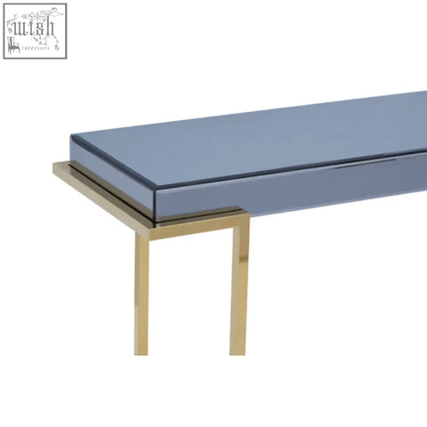 Kaso console table with a sleek grey glass top and slender gold-toned stainless steel legs for modern style