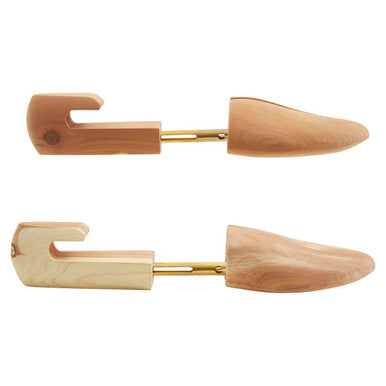 Light brown cedar wood kata d sparrow shoe shapers with gold metal rod for maintaining shoe shape