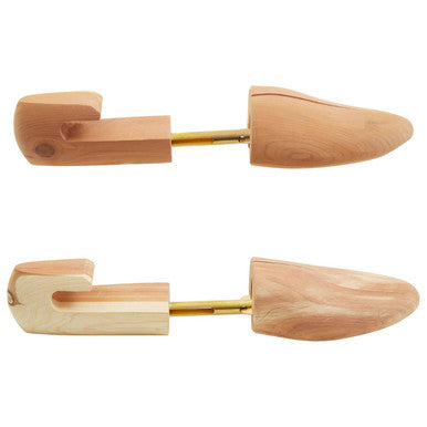 Light brown cedar wood shoe shapers with smooth polished finish and gold metal shafts for shoe care