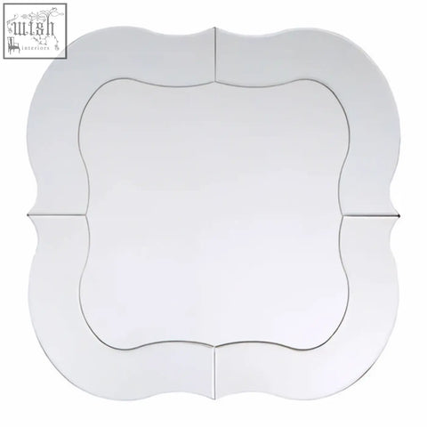 A sleek katelyn silver rounded wall mirror with a decorative scalloped frame and clean white edges