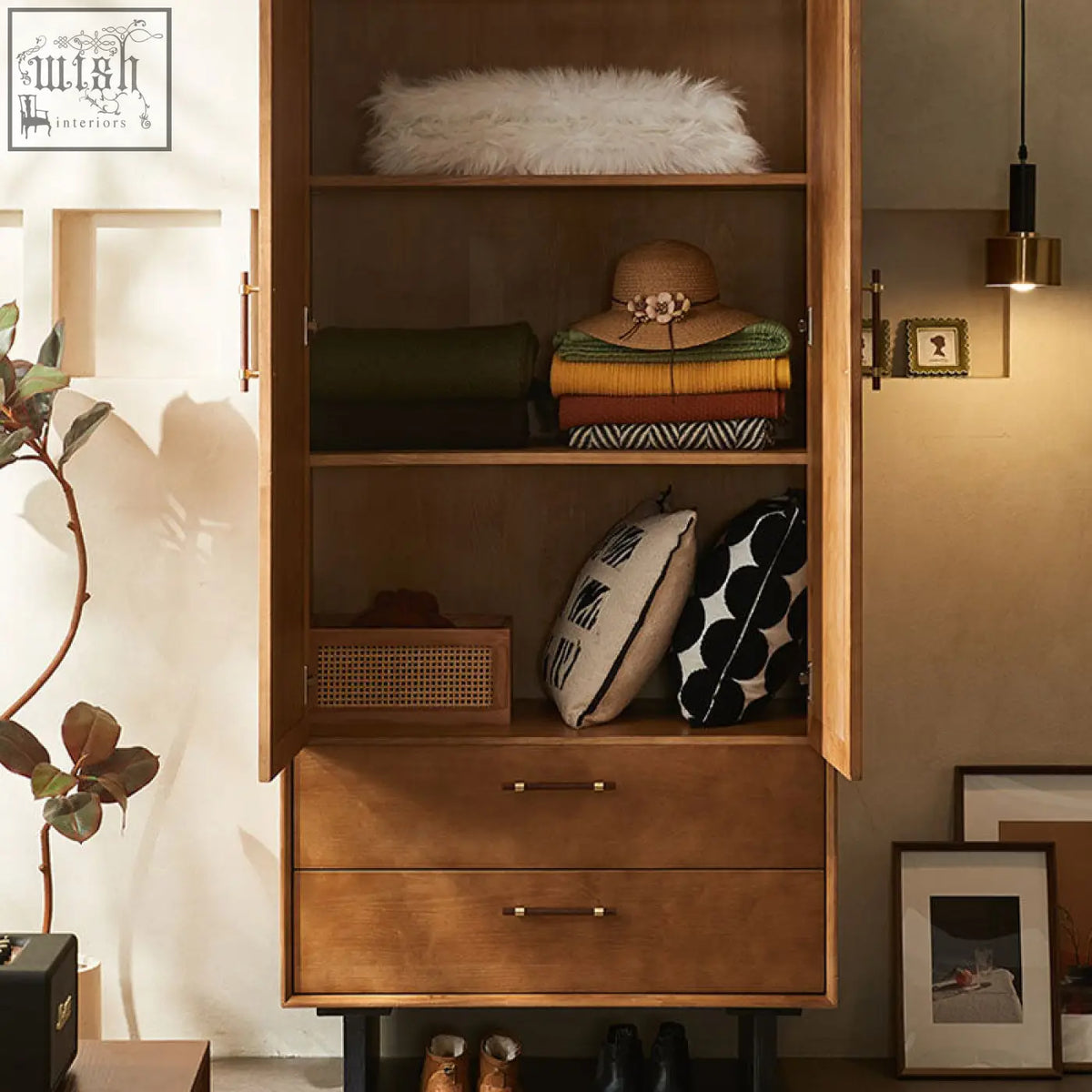 Warm-toned wooden kaylee rattan wardrobe with open shelves, two drawers, brass handles, and black metal legs