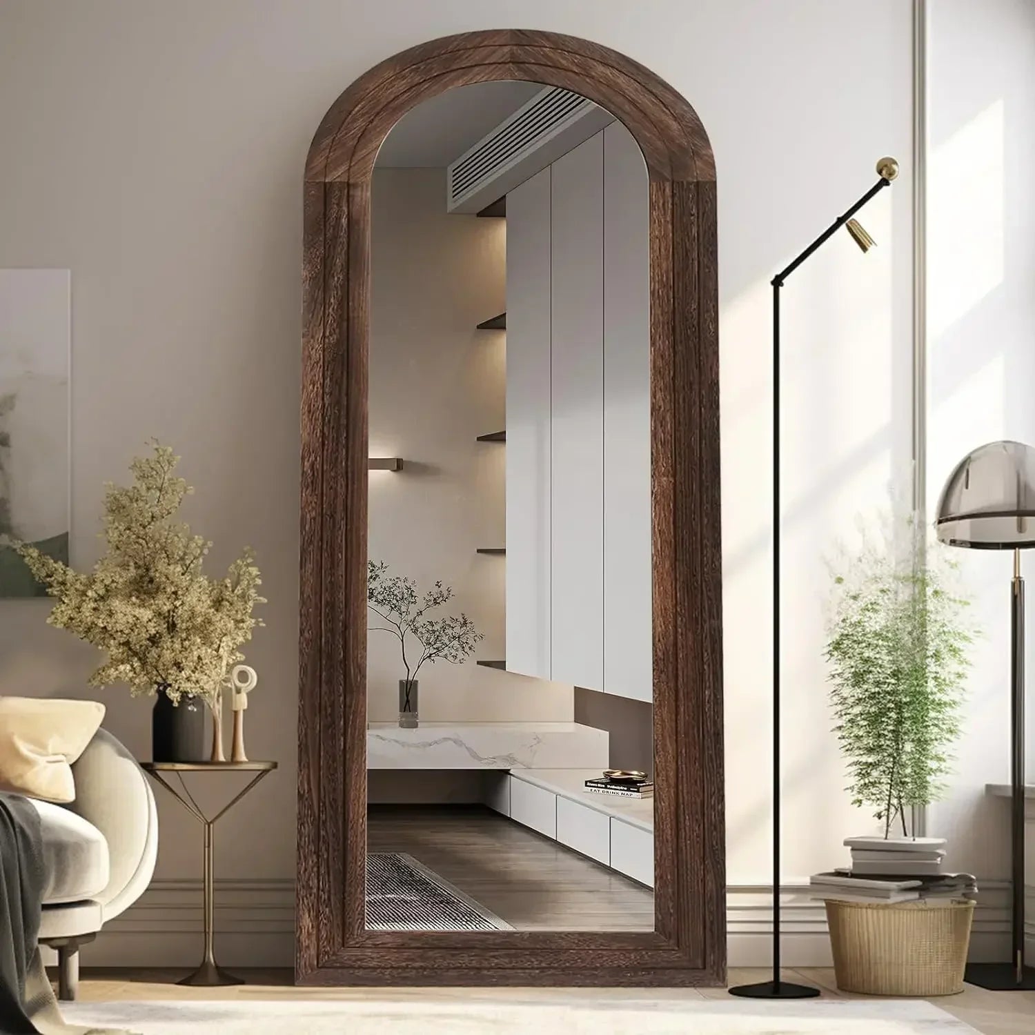 A tall arched kayo mirror with a rustic wooden finish and visible grain perfect for farmhouse decor