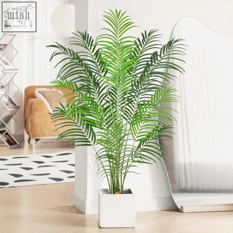 A tall lush green keeplush artificial palm tree with long fronds in a white square pot for indoor home decor