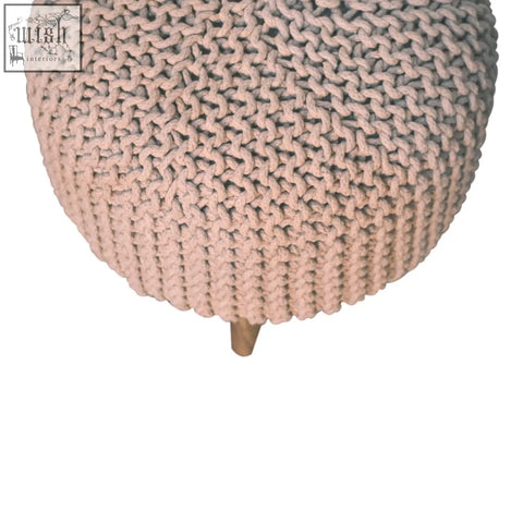 Keeva beige round footstool with a soft blush pink chunky knit pouf and wooden legs in beige fabric