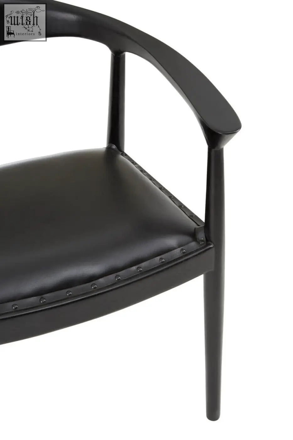 Black leather kendari black chair with sleek curved teak wood frame and subtle nailhead trim on seat edge