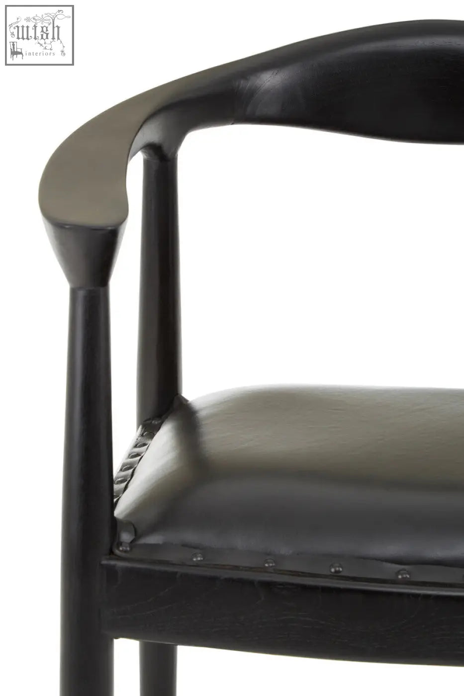 Kendari black leather chair with sleek curved teak wood frame and subtle metallic rivets along seat edge