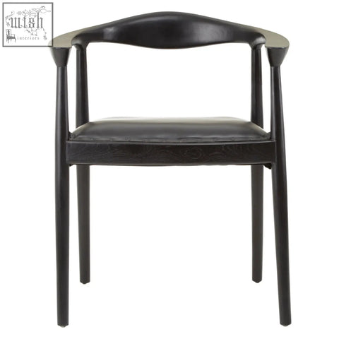 Black leather kendari black leather armchair with sleek minimalist design and curved teak wood frame