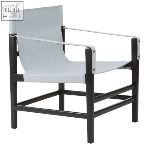 Black-framed kendari grey leather armchair with light gray canvas straps and silver metal hardware on teak wood frame