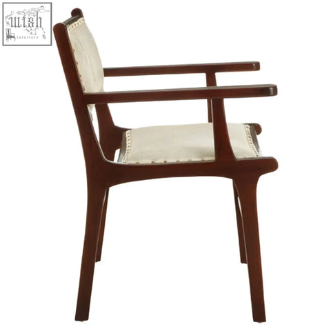 A sleek teak wood dining chair with dark wood frame and cream fabric seat perfect for wood dining setups
