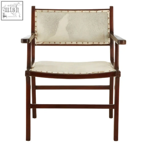 A sleek dark wood dining chair with cream leather seat and brass rivets made from teak wood for dining use