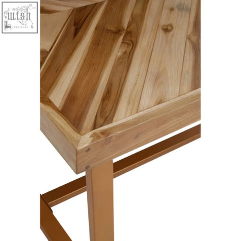 A kendari natural teak wood dining table with a slanted top made of light wood panels and metal legs