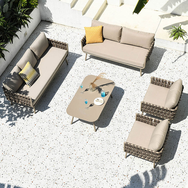 Beige kenneth outdoor sofa set with woven wicker frames and matching cushions including sofa armchairs and coffee table
