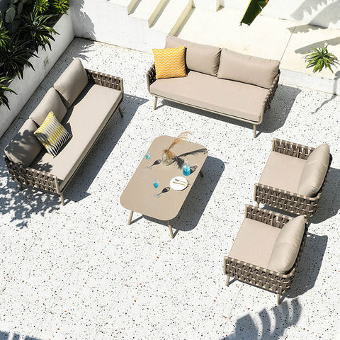 Beige kenneth outdoor sofa set with woven wicker frames and matching cushions including sofa armchairs and coffee table