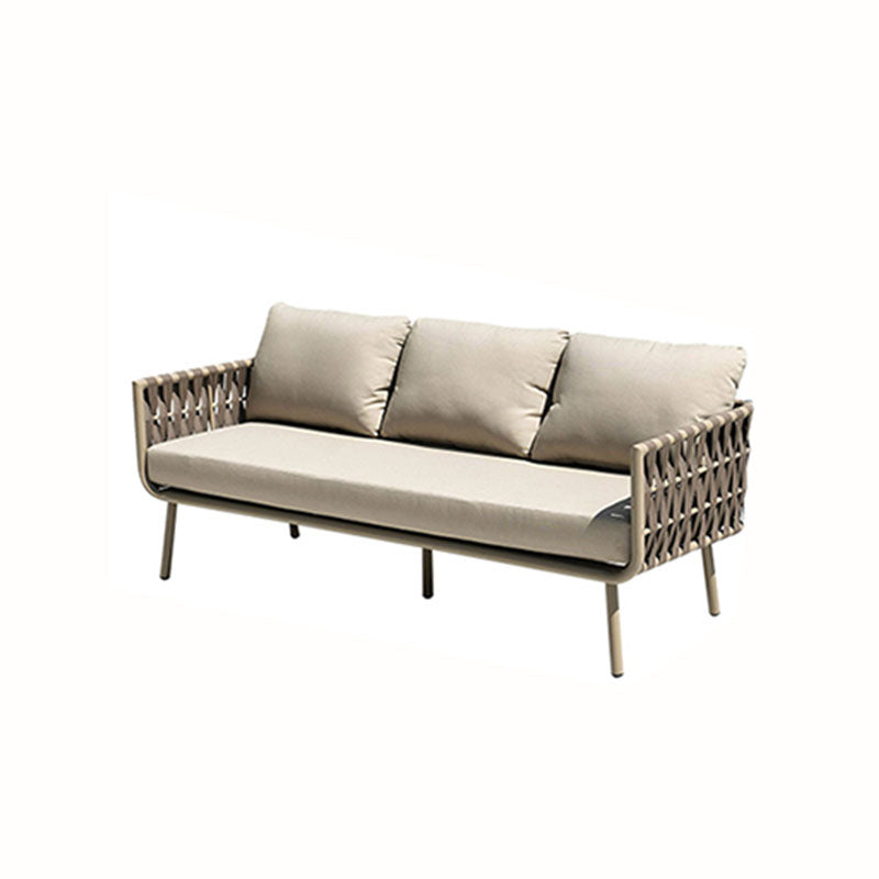 Beige woven wicker kenneth outdoor sofa with three cushions and slim metal legs in outdoor sofa set
