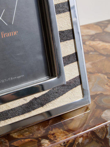 A sleek 5x7 zebra design photo frame with black and beige striped texture and polished silver metal border