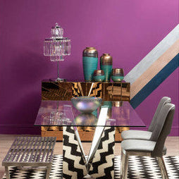 The kensington townhouse bulbs table lamp sits on a sleek glass-top table with reflective surface and metallic legs