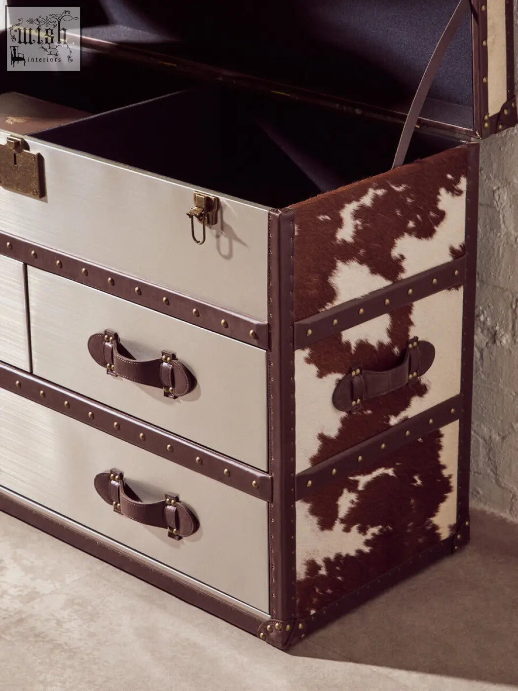 Vintage-style kensington townhouse brown white cowhide cabinet trunk with cream body, brown cowhide accents, brass hardware, and leather handles