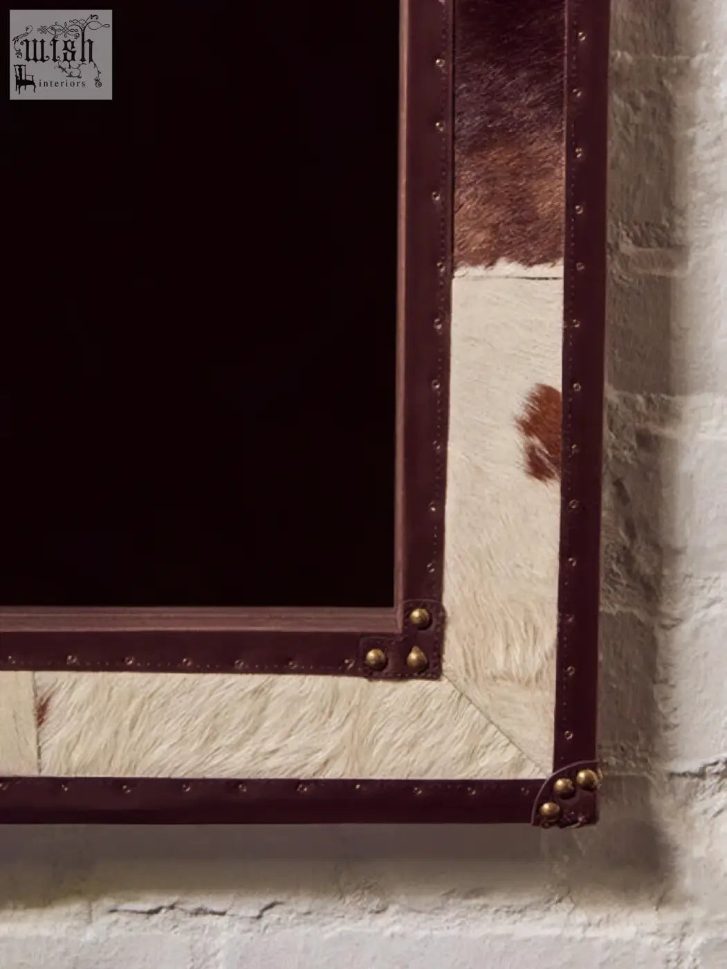 Rustic genuine cowhide wall mirror with brown and white white genuine cowhide frame and dark metal accents