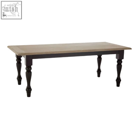Kensington townhouse dining table with black wooden frame, light smooth top, and classic turned legs for townhouse dining rooms