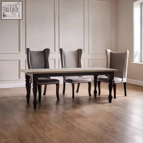 Elegant kensington townhouse dining table with light gray stone top and dark wood legs paired with upholstered chairs