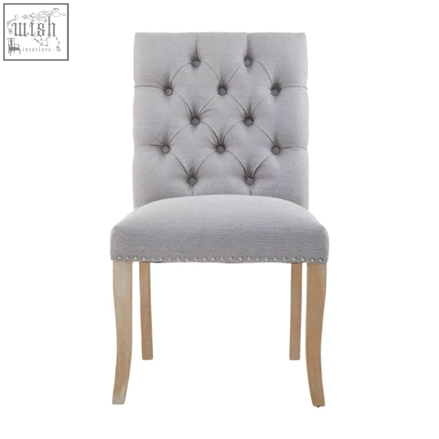 Grey linen dining chair with tufted grey linen upholstery and light wood legs perfect for dining spaces