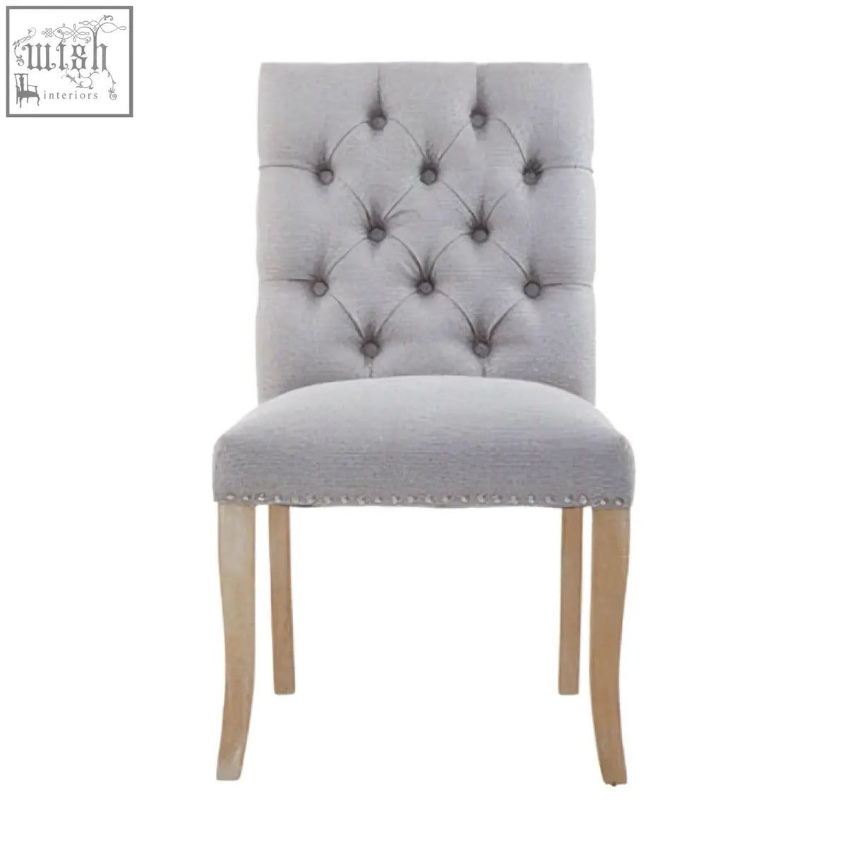 Grey linen dining chair with tufted grey linen upholstery and light wood legs perfect for dining spaces