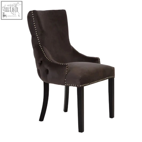 Dark brown velvet dining chair with black legs and nailhead trim from kensington townhouse grey velvet collection