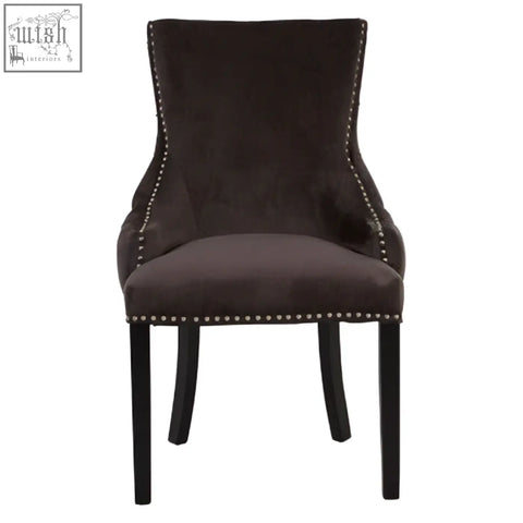 Dark brown velvet dining chair with black metal legs and silver nailhead trim in kensington townhouse grey style