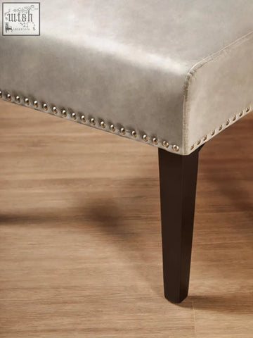 Gray velvet bench with silver nailhead trim and dark wood legs perfect for kensington townhouse grey dining spaces