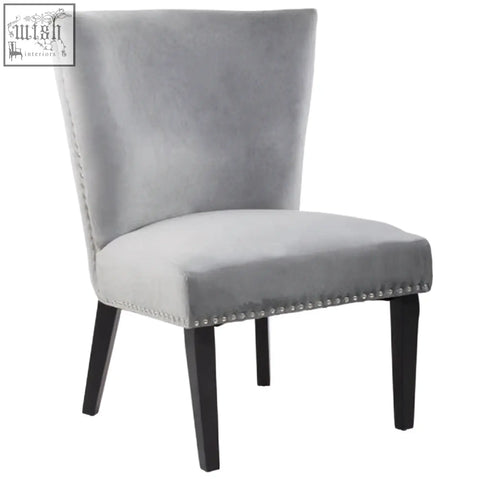 Kensington townhouse grey winged dining chair in gray velvet with black wood legs and nailhead trim along seat edge