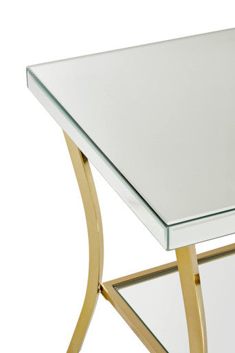 Kensington townhouse mirror side table with gold legs featuring a gold-toned metal frame and mirrored glass top and shelf