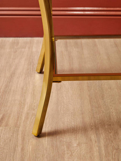 Gold-finished curved iron legs on kensington townhouse mirror side table providing elegant metal support