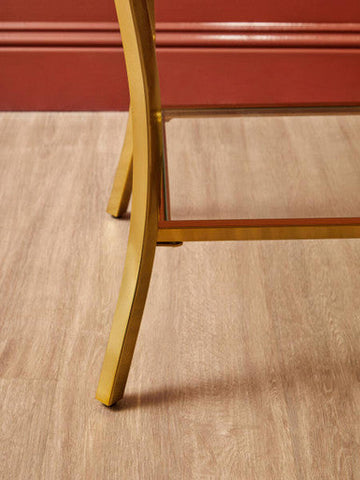 Gold-finished curved iron legs on kensington townhouse mirror side table providing elegant metal support