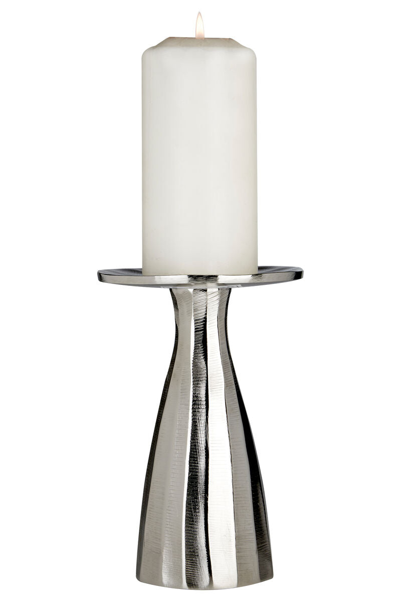 A sleek small silver candle holder with textured fluted design holding a tall white pillar candle