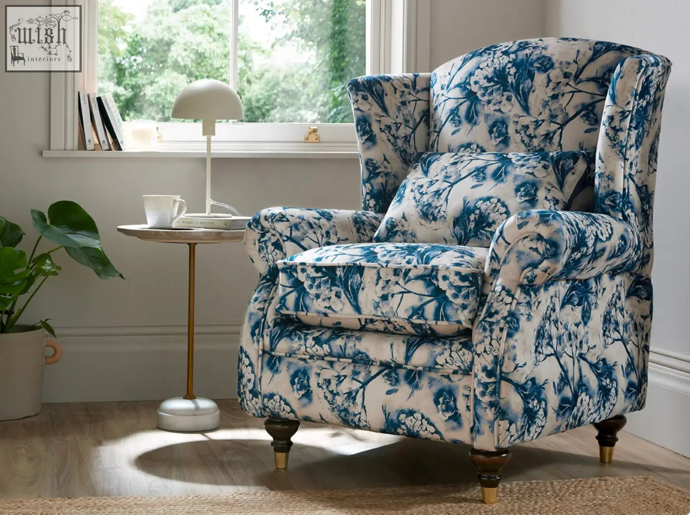 Blue and white floral patterned wing chair with wooden legs perfect for cozy living room seating