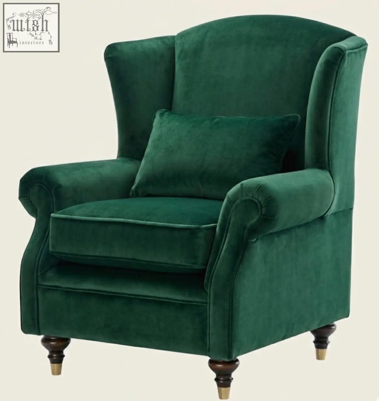 Deep emerald green velvet wing chair with wingback design dark wood legs and gold feet perfect for a stylish living room
