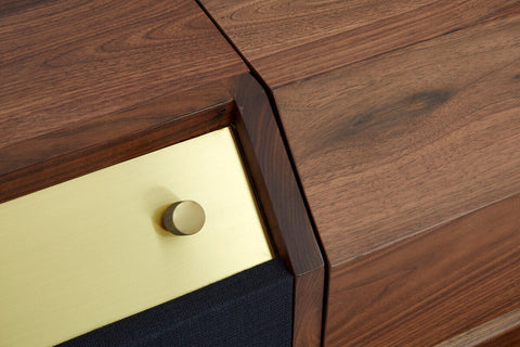 Dark wood kenso sideboard drawer front with polished brass knob and black fabric panel on natural sideboard design