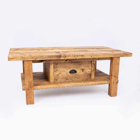Keswick coffee table made of reclaimed wood with a drawer and lower shelf in natural light brown tones. free furniture care