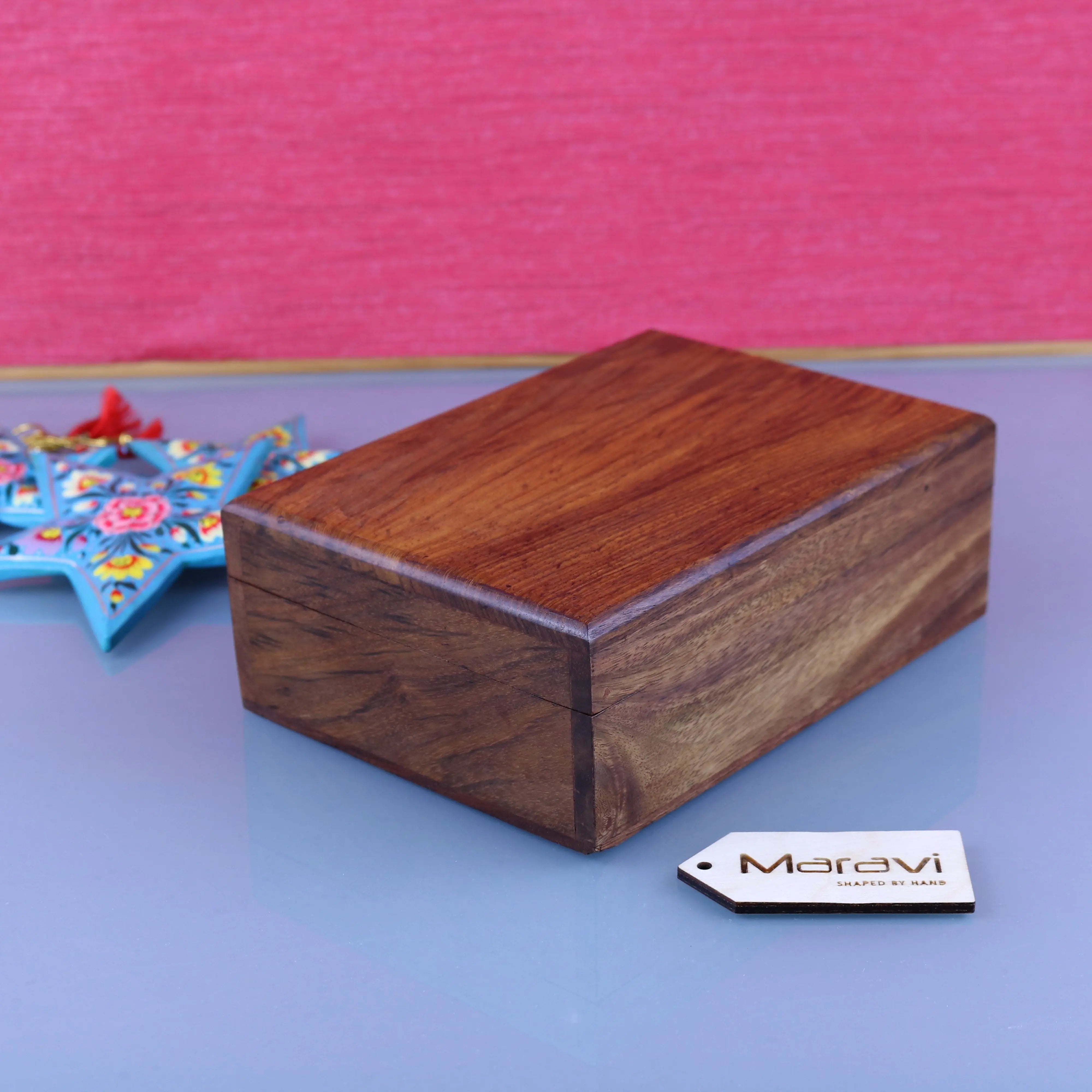 A rectangular wooden storage box with warm brown finish and natural wood grain from Khalka Plain storage boxes