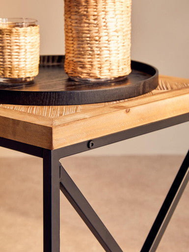 Black metal x-frame side table with light parquet fir wood top and woven rattan accents fir wood coffee table style