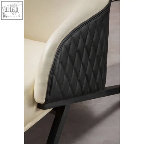 Black quilted faux leather accent panel on the back of the kiev ivory armchair with cream upholstery