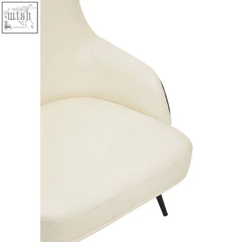 Cream-colored kiev ivory armchair with sleek modern design, faux leather upholstery, and black metal legs