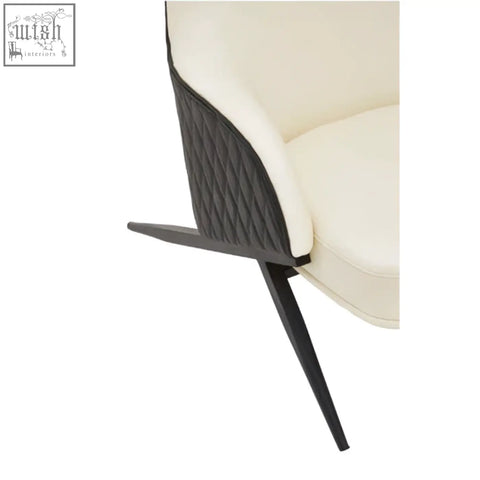Cream-colored faux leather kiev ivory armchair with black quilted accent panel and sleek tapered legs
