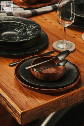 Black ceramic plates with subtle marbled texture stacked on rustic table for kindia white marble round coasters set