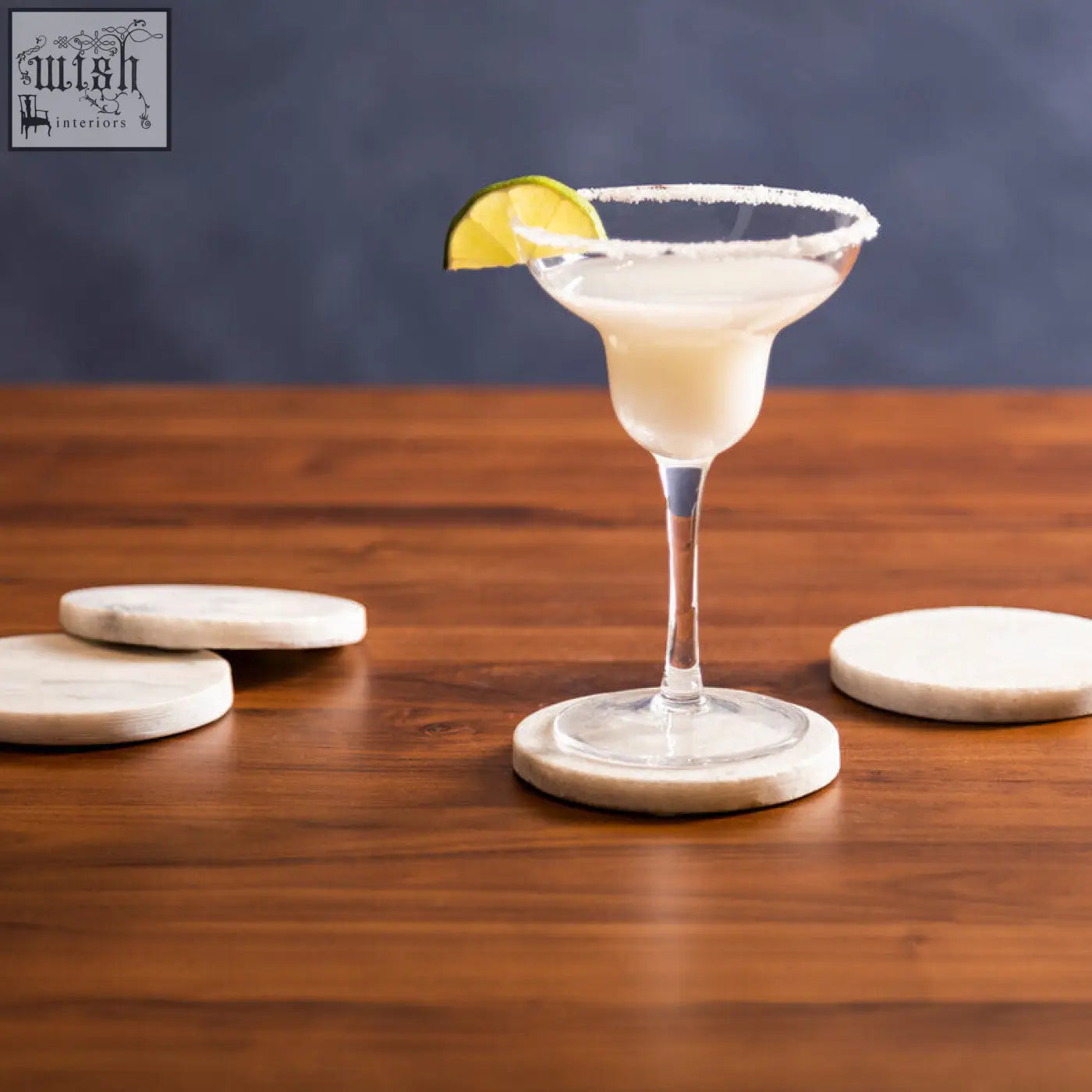 A clear margarita cocktail with lime on white marble round coasters from kindia set of 4 marble round coasters