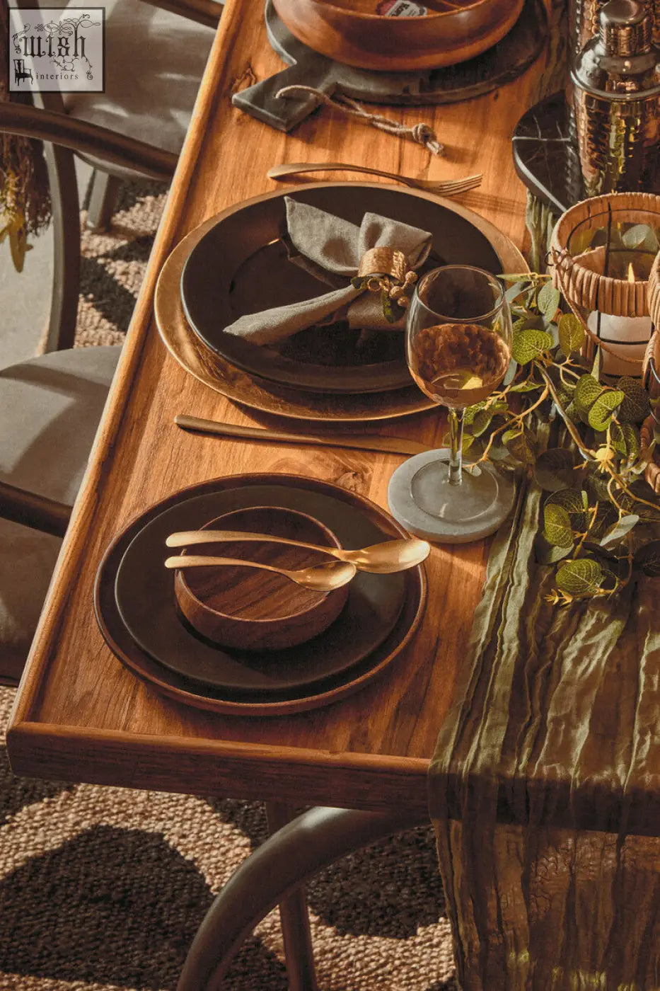 Dark brown ceramic plates with matte finish on white marble round coasters paired with gold-toned cutlery