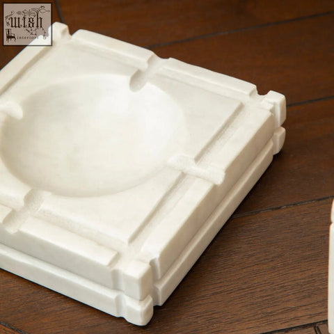 Kira white marble ashtray with a square geometric design and four cigarette slots made of white marble