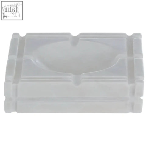 Transparent plastic ashtray with rectangular shape and multiple cigarette indentations in kira white marble ashtray style